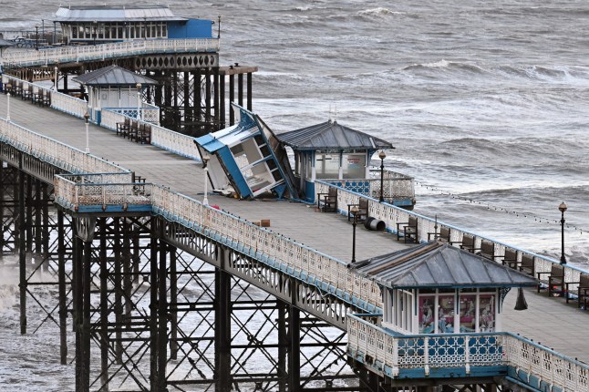 Damage to the kiosks on the pier at Llandudno in north Wales is seen on December 8, 2024, after storm darragh brings winds of 90 mph to the west of Wales and north-west England. High winds and heavy rain have battered western parts of the United Kingdom, causing widespread travel disruption. (Photo by Paul ELLIS / AFP) (Photo by PAUL ELLIS/AFP via Getty Images)