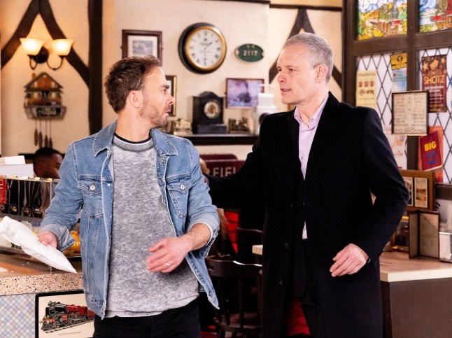 Nick approaching David in the cafe in Corrie
