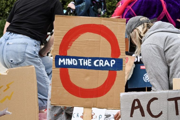 FALMOUTH, ENGLAND - MAY 17: Close up of a protestor's sign during the SAS Paddle Out from Gyllyngvase Beach on May 17, 2025 in Falmouth, England. Surfers Against Sewage are staging 'Paddle Out' protests across the UK to demonstrate against the levels of sewage in British waterways. For England alone,the Environment Agency reported a total of??450,398??discharges, accounting for 3.6 million hours of raw sewage being spilled into rivers. The protests come amid a growing crisis in management and regulation of UK water companies, which are responsible for self-reporting sewage spills. (Photo by Hugh R Hastings/Getty Images)