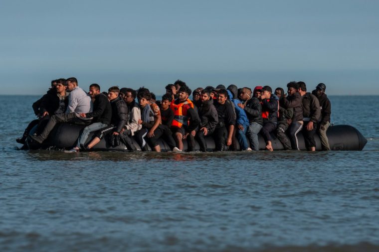 GRAVELINES, FRANCE - JUNE 17: Migrants sit on a dinghy as they wait to sail into the English Channel on June 17, 2025 in Gravelines, France. A record number of migrants have made the illegal crossing from France to the UK via small boats so far this year. Figures surpassed the 16,000 mark last week, which is 42% more than the same point last year. The UK government has vowed to crackdown on people smugglers and illegal migration, with Chancellor Rachel Reeves announcing as part of the government's spending review that the Border Security Command would be funded up to ??280m more per year by the end of the review period in 2028-29. (Photo by Carl Court/Getty Images)