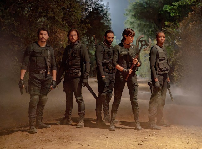 This image released by Netflix shows, from left, Henry Golding, Luca Marinelli, Marwan Kenzari, Charlize Theron and KiKi Layne in a scene from 