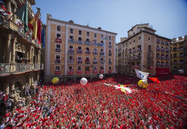 People celebrate during the launch of the 'Chupinazo' rocket, to celebrate the official opening of the 2016 San Fermin Fiestas, in Pamplona, Spain, Wednesday, July 6, 2016.; Shutterstock ID 459144976; purchase_order: -; job: -; client: -; other: -