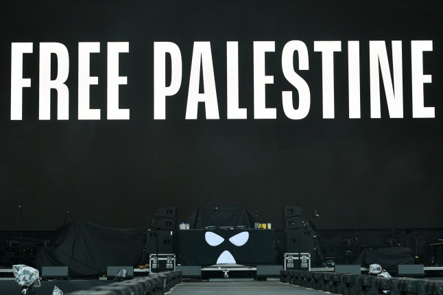 LONDON, ENGLAND - JULY 05: A message of support for Palestine is screened before Kneecap take to the stage at Finsbury Park, as support to Fontaines DC, on July 05, 2025 in London, England. (Photo by Jim Dyson/Getty Images)