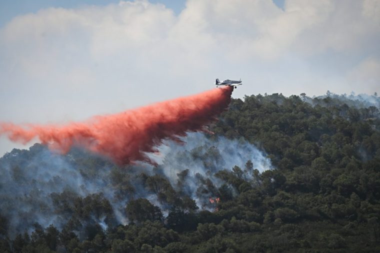 A fire-fighting aircraft Air Tractor AT-802 drops fire retardant over a wildfire near Aussieres neighbourhood, close to the city of Narbonne, southwestern France, on July 8, 2025. (Photo by Matthieu RONDEL / AFP) (Photo by MATTHIEU RONDEL/AFP via Getty Images)