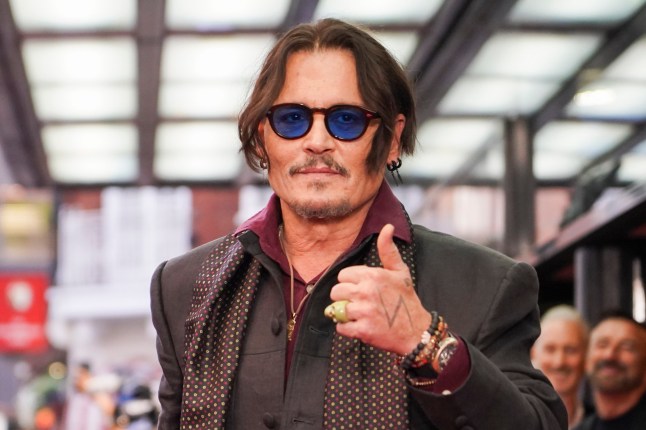 Johnny Depp poses upon arrival at the premiere of the film 