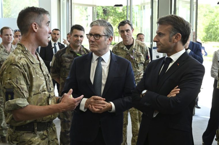 British Prime Minister Keir Starmer, centre, and French President Emmanuel Macron, right, look at screens during a joint military visit to the MARCOM centre, maritime command centre in Northwood, London, Thursday July 10, 2025. (Leon Neal/Pool Photo via AP)