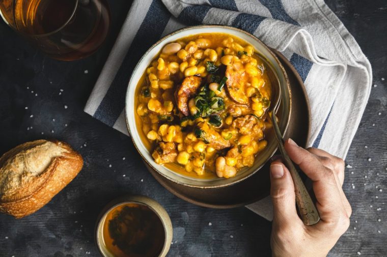 Personal perspective of woman eating traditional locro stew