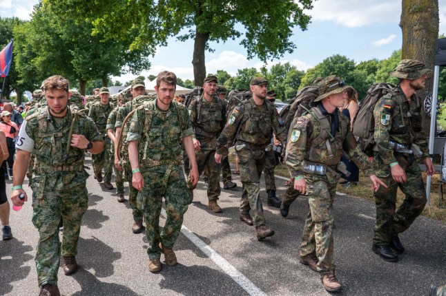 Mandatory Credit: Photo by Orange Pictures/Shutterstock (15403527a) GROESBEEK, NETHERLANDS - JULY 17: Day 3 of the Four Day Marches (Vierdaagse / 4daagse), the world's biggest multi-day walking event with about 47.000 participants. Picture depicts a group of german soldiers. On July 17, 2025 in Groesbeek, Netherlands. (Photo by Lucia Smatanov?/Orange Pictures) Day 3 of the Four Day Marches (Vierdaagse / 4daagse), the world's biggest multi-day walking event with about 47.000 participants. Picture depicts a group of german soldiers. On July 17, 2025 in Groesbeek, Netherlands. - 17 Jul 2025
