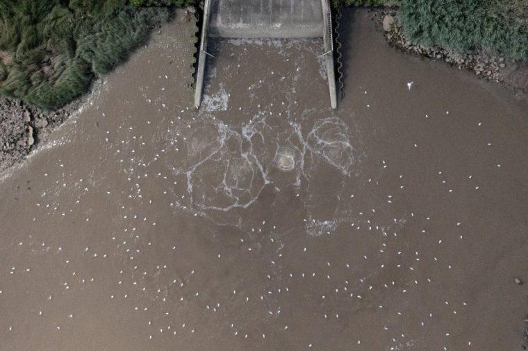 (FILES) An aerial view shows the outfall into the River Thames, at Thames Water's Crossness Sewage Treatment Works, in south east London on July 3, 2023. The UK government announced July 21 2025, it will overhaul the management and regulation of the water system, following a landmark report that slammed systematic failings in the heavily-criticised industry. The move comes after years of angry complaints about the privately-run system and its much-maligned regulator Ofwat, including constant leaks and raw sewage being discharged into waterways and oceans. (Photo by Ben Stansall / AFP) (Photo by BEN STANSALL/AFP via Getty Images)