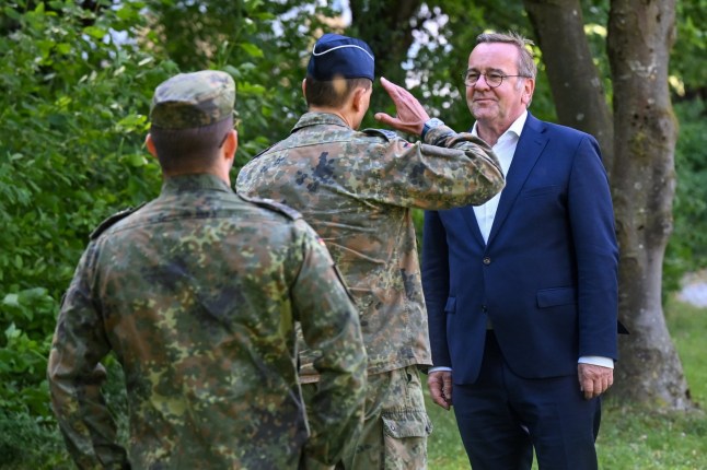 A soldier salutes German Defence Minister Boris Pistorius as he visits a paramedic academy of the German army, Bundeswehr, in Munich, Germany, July 22, 2025. REUTERS/Angelika Warmuth