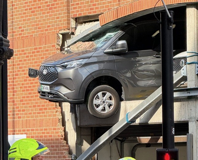 Car sticking out of car park.