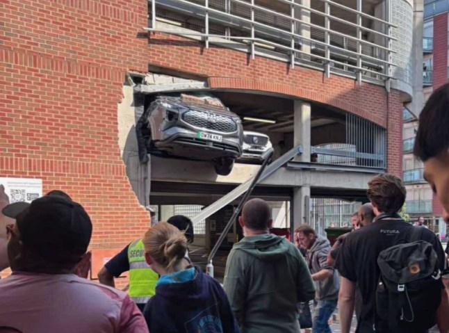Car crashes through barrier at multi storey car park.