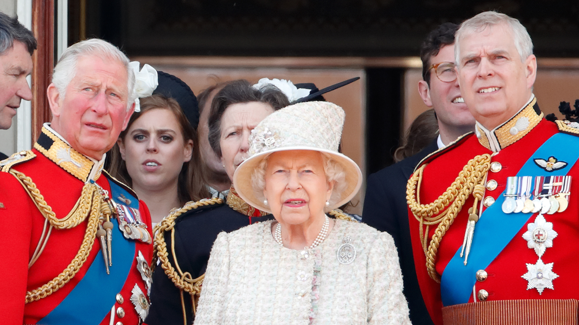 King Charles and Prince Andrew wear red military uniforms as they stand on the Buckingham Palace balcony with Queen Elizabeth II