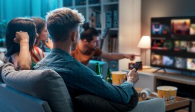 A group of friends sitting on a couch, looking for something to watch on a streaming platform.