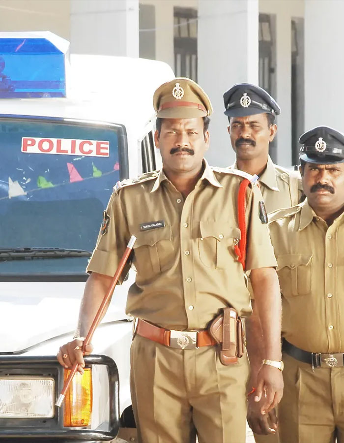 Three Indian police officers in uniform standing in front of a police vehicle representing male ego and tennis pro shooting case.