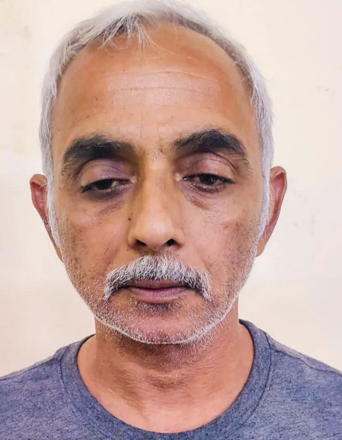 Middle-aged man with gray hair and mustache against a neutral background related to male ego controversy in tennis case.
