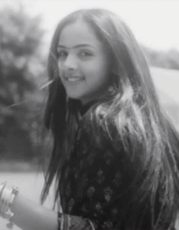Young female tennis pro smiling outdoors with long hair, related to male ego controversy over fatal shooting by dad.