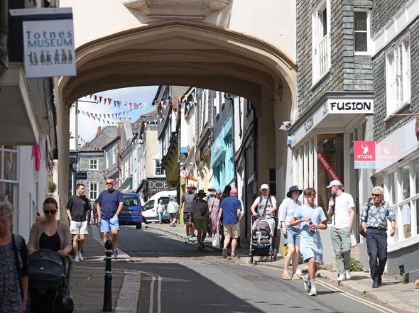 Totnes high street bustling with activity on a Thursday morning