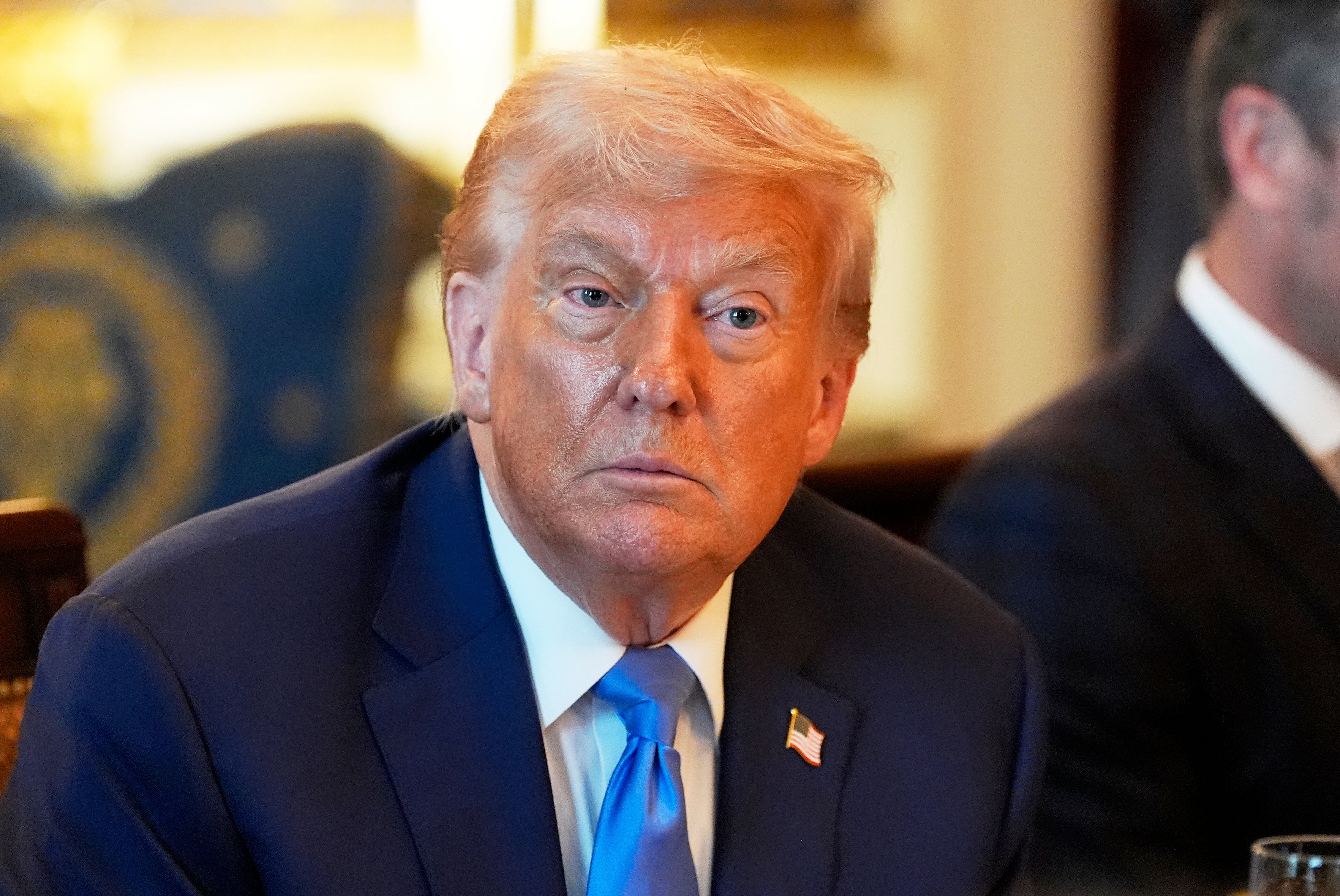 President Donald Trump listens during a meeting with Israel's prime minister Benjamin Netanyahu in the Blue Room of the White House