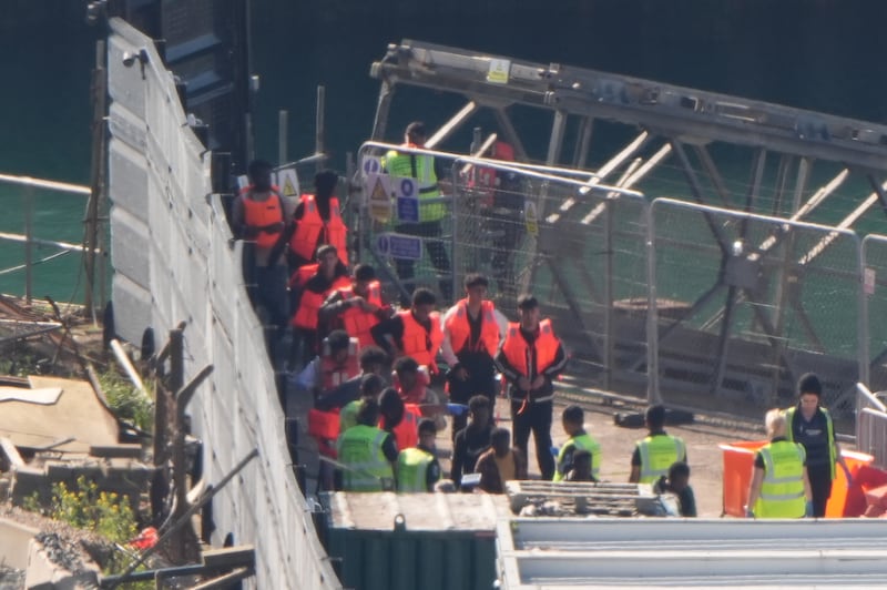 A group of people thought to be migrants are brought in to the Border Force compound in Dover, Kent, from a Border Force vessel
