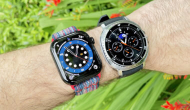 Close up of the Samsung Galaxy Watch Ultra 8 and Apple Watch Series 10 next to each other against a green, foliage background