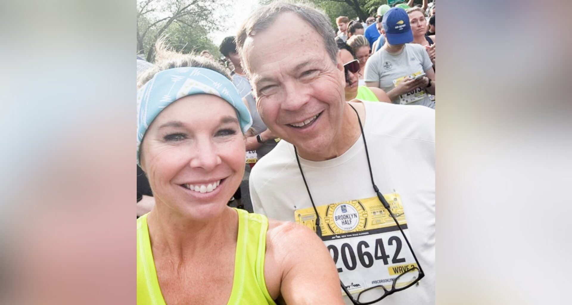Woman and man in a crowd take selfie of themselves smiling