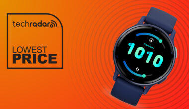 A Garmin smartwatch on a yellow-red background