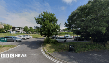 A car park with trees around it.