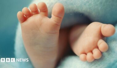 Close up of baby's feet on a blue blanket