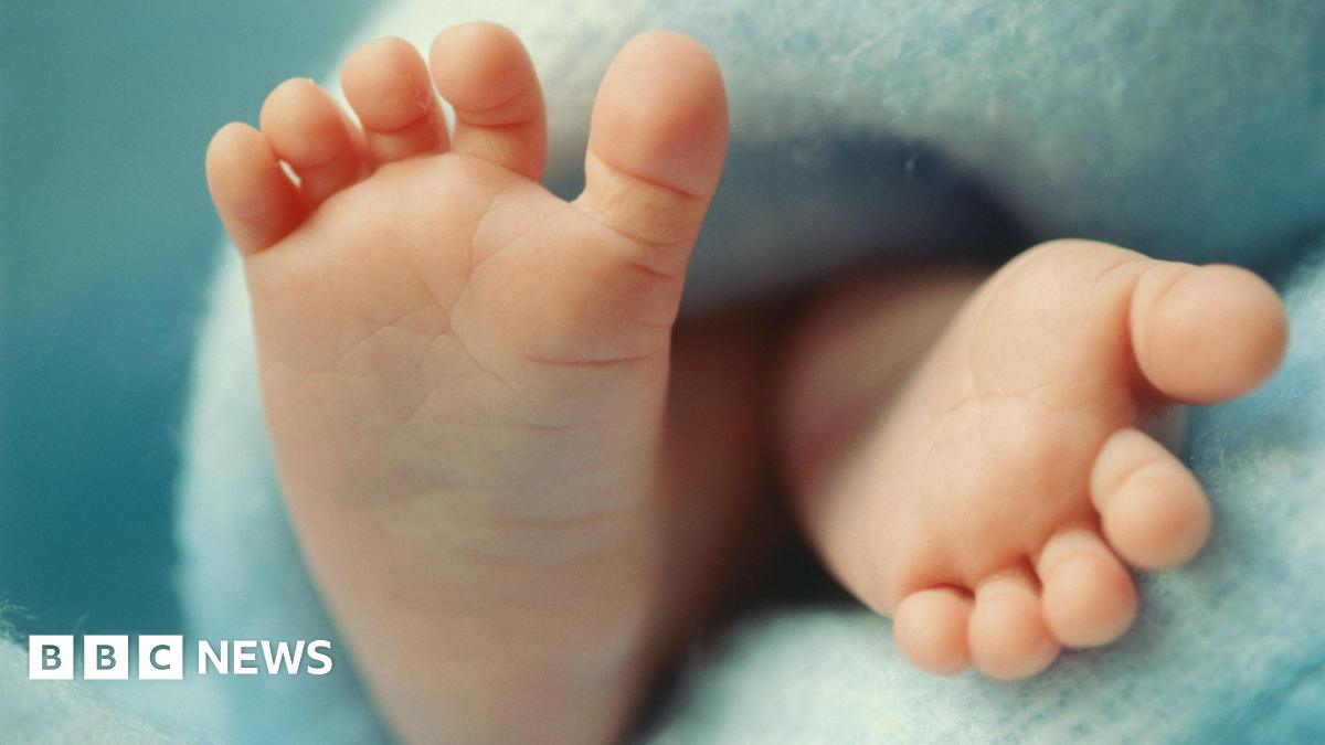 Close up of baby's feet on a blue blanket