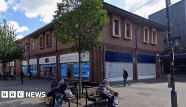 A closed former Boots store occupying a corner plot in a modern building