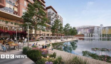 An artists impression shows the YTL Arena in the distance. In the foreground people sit and walk beside a lake with fountains, lined with cafes and restaurants. Apartment blocks rise above the ground level.