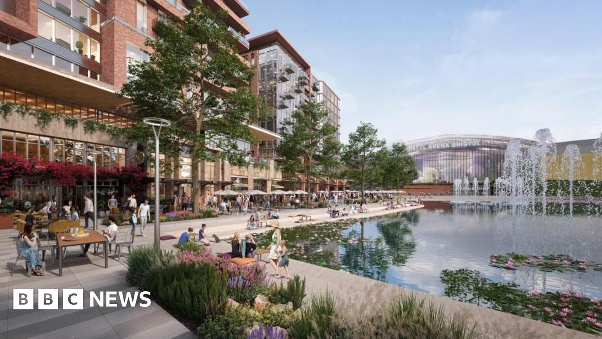An artists impression shows the YTL Arena in the distance. In the foreground people sit and walk beside a lake with fountains, lined with cafes and restaurants. Apartment blocks rise above the ground level.