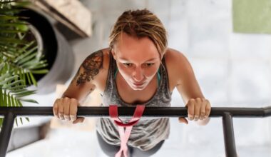 a shot from above of a woman performing a pull-up. there's a plant to the side of her and tiled floor beneath her.