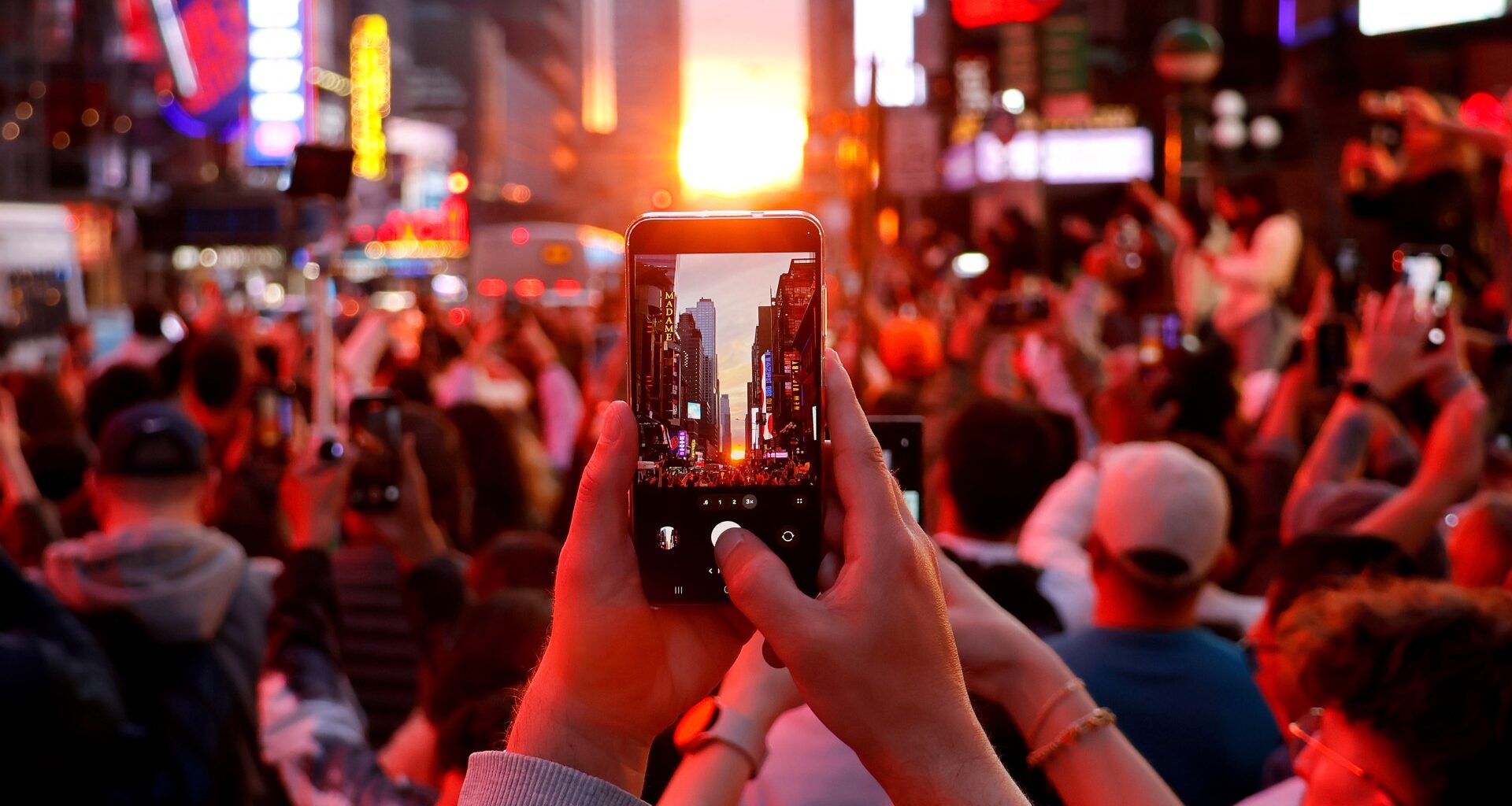 A crowd looks at the sunset in Manhattan