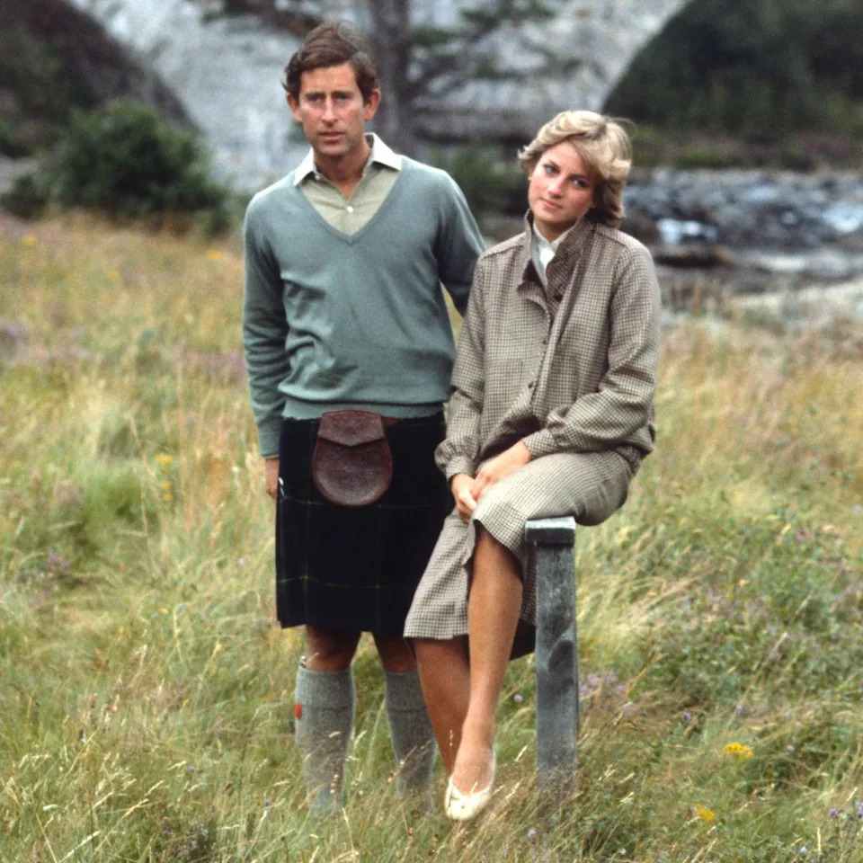 Prince Charles and Princess Diana on honeymoon at Balmoral standing in the grass along the river. 