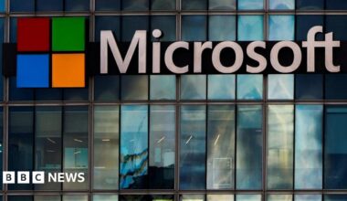 The Microsoft logo is lit up on a glass building in Paris
