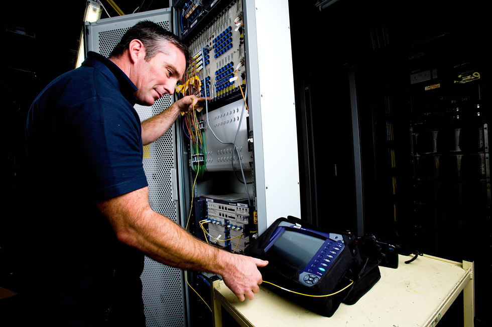 an openreach engineer pictured testing the new broadband technology that enables faster download speeds over the existing full-fibre connection