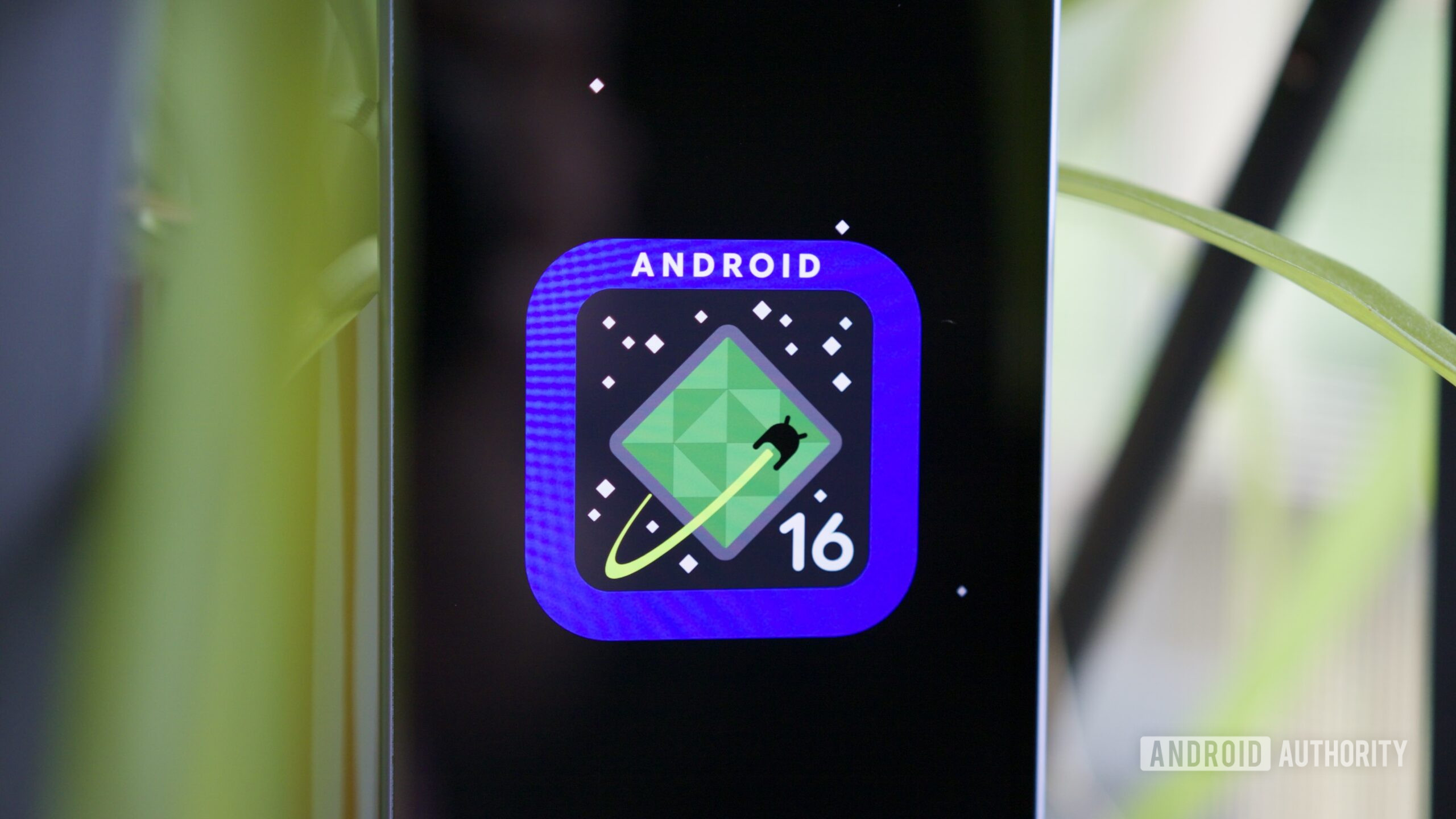 Android 16 logo on a Google Pixel phone.