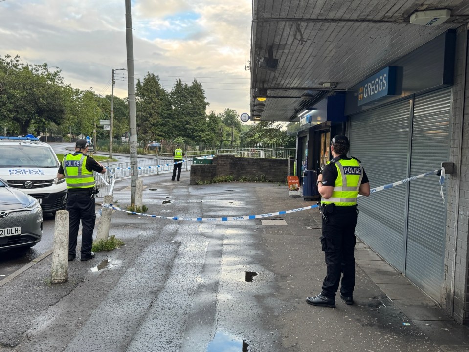 Police officers at the scene of an armed robbery in Glasgow.