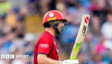 Jos Buttler raises his bat to acknowledge his 50 for Lancashire against Yorkshire at Headingley