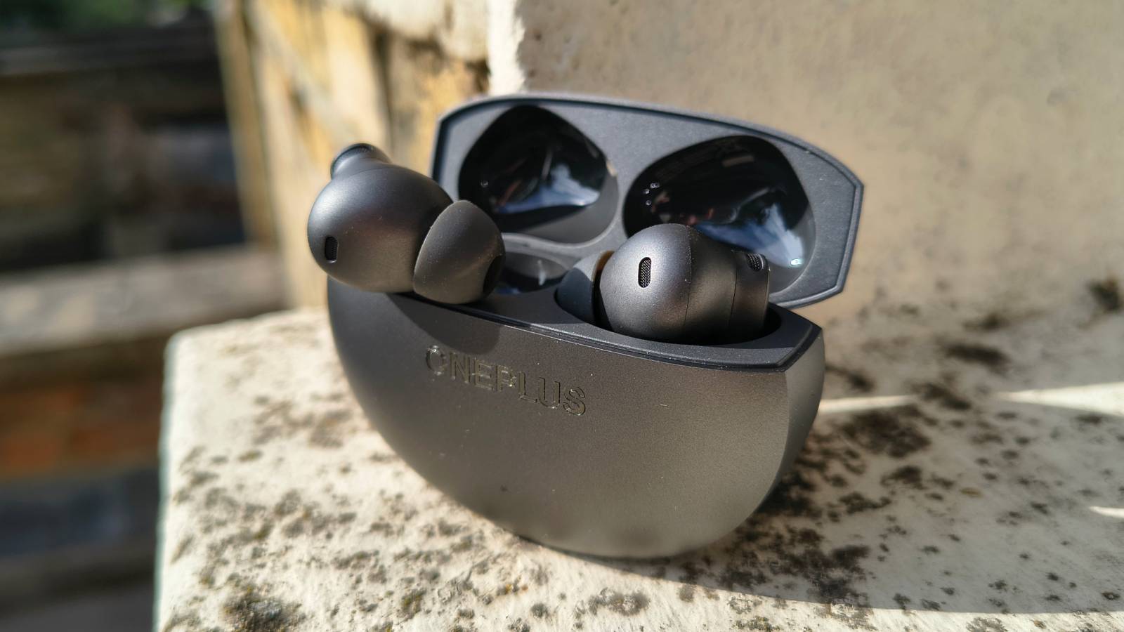 The OnePlus Buds 4 on a window sill.