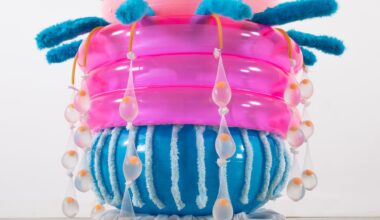 an abstract inflatable artwork that resembles a pink and blue, alien-like creature