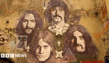 A mural on a brick wall of Black Sabbath band members