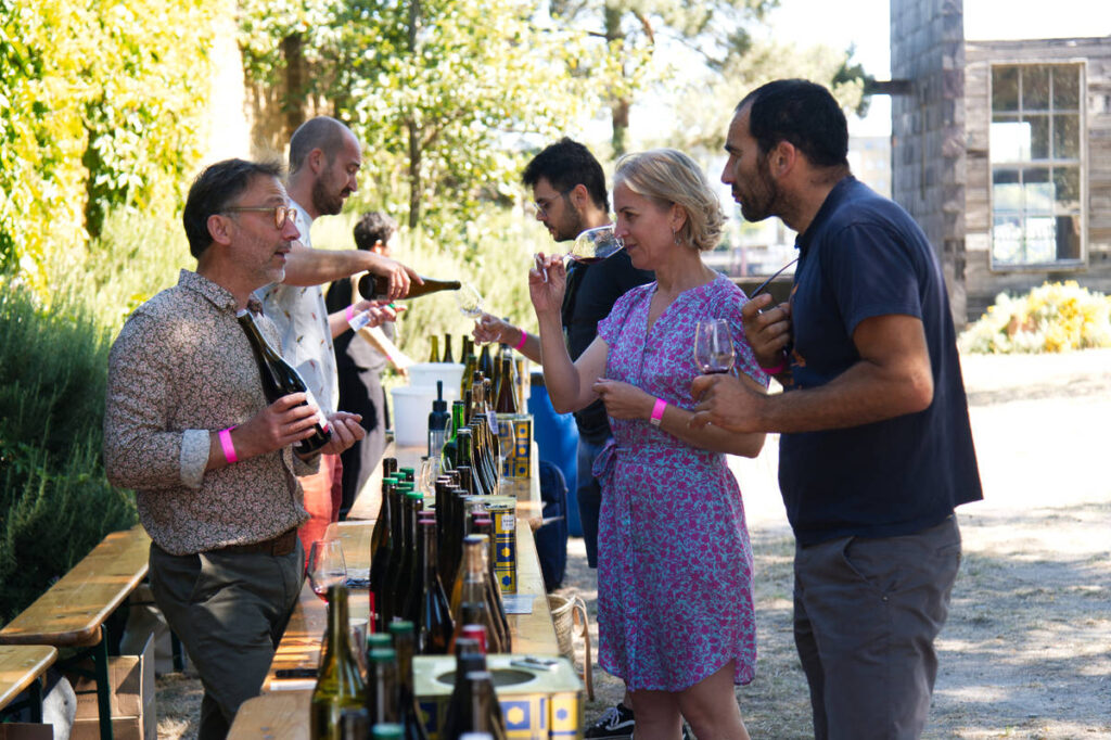people talking to wine makers while tasting their wine