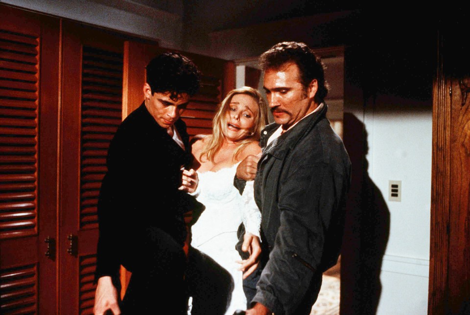 Scene still from *Licence to Kill* showing Benicio Del Toro, Priscilla Barnes, and Don Stroud.