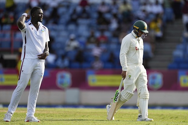 Usman Khawaja trudges off.