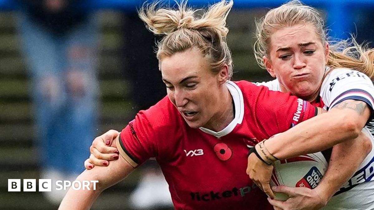 Beth Dainton on Wales is tackled against England