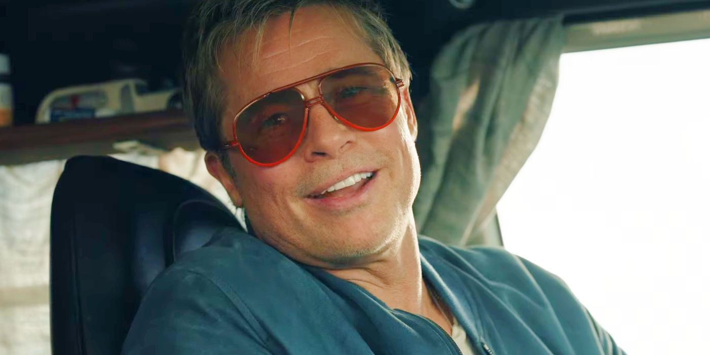 Brad Pitt as Sonny Hayes smiling in his sunglasses in F1 The Movie