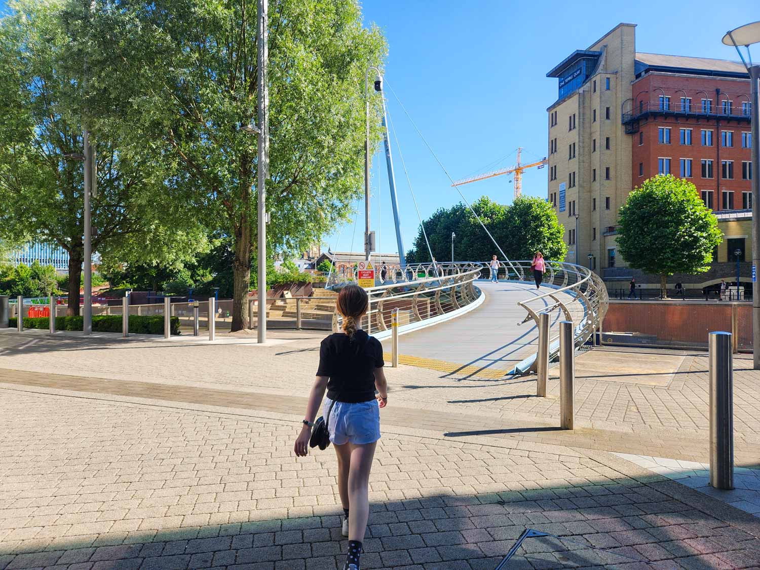 My daughter walks towards one of the bridges by the water on the hunt for statues on the Gromit Unleashed 3 trail - my review
